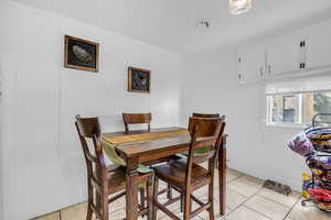 Dining room with light tile patterned flooring