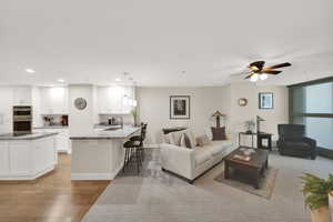 Living room/kitchen area featuring light hardwood / wood-style flooring.