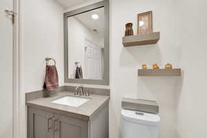 Half Bathroom with vanity and toilet