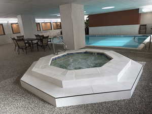 Indoor hot tub in community pool area.