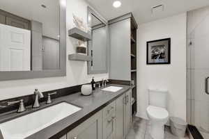 Owner's suite featuring large double  vanity, shower.