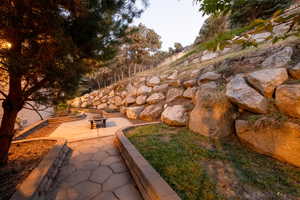 View of property's community featuring a patio and a fire pit