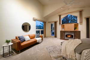 Bedroom featuring access to exterior, carpet flooring, vaulted ceiling, and ceiling fan