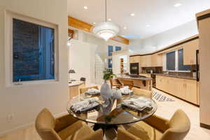 Dining space with sink and light wood-type flooring