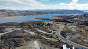 Birds eye view of property featuring a water and mountain view