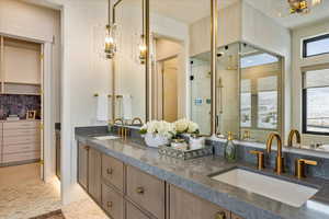 Bathroom with vanity, an enclosed shower, and backsplash