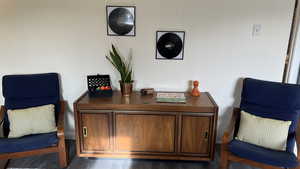 Office space with dark hardwood / wood-style flooring