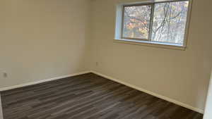 Spare room featuring dark hardwood / wood-style flooring