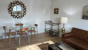 Sitting room with crown molding and light hardwood / wood-style flooring