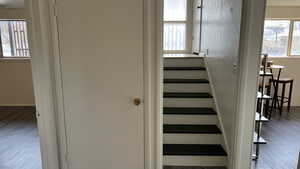 Stairway featuring hardwood / wood-style flooring