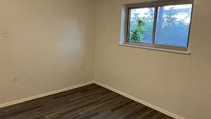 Unfurnished room featuring dark hardwood / wood-style flooring