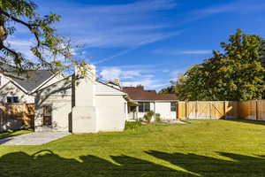 Rear view of property featuring a patio and a lawn