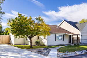 View of front of house with a garage and a front lawn