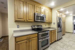 Kitchen with appliances with stainless steel finishes