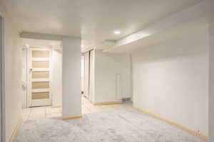 Basement featuring light tile patterned floors