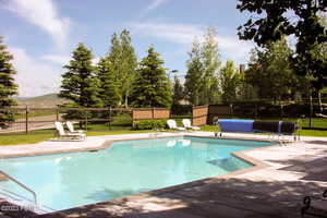 View of swimming pool with a patio area and a mountain view