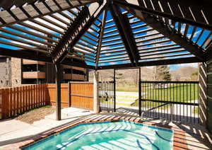 View of swimming pool featuring a pergola, a mountain view, a lawn, and a patio area