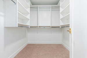 Primary walk-in closet with adjustable shelving