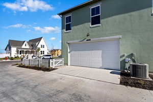 View of home's exterior featuring a garage and central AC unit