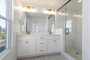 Primary Bathroom with double vanity and walk in shower