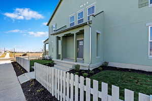 View of home's exterior featuring a yard and a second covered porch