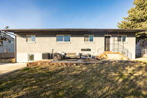 Rear view of property featuring a lawn, outdoor lounge area, and a patio area