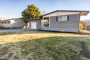 View of front facade with a front yard and a garage