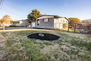 View of front of home featuring a front yard and a garage