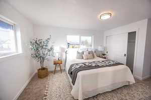 Carpeted bedroom featuring a closet