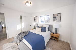 Bedroom with hardwood / wood-style floors and a closet