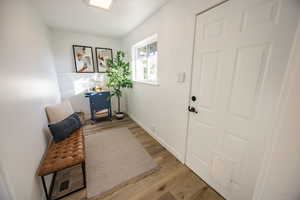 Foyer with light hardwood / wood-style flooring