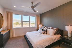 Bedroom with dark carpet, a mountain view, multiple windows, and ceiling fan