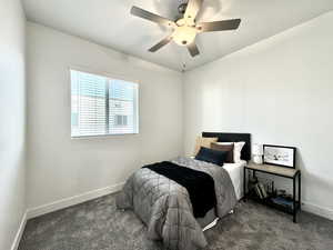 Bedroom featuring dark colored carpet and ceiling fan