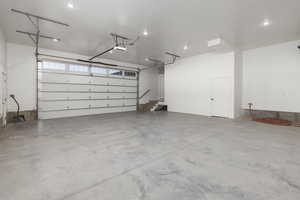 Heated garage with a hot and cold hose bibb, electric car outlet, and high enough to accommodate a boat with a tower