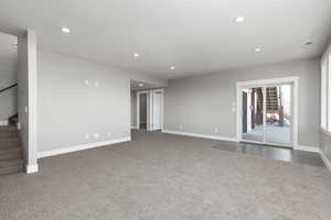 Family room featuring dark carpet, and sliding glass door to patio