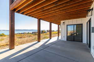 View of patio / terrace featuring a water and mountain view