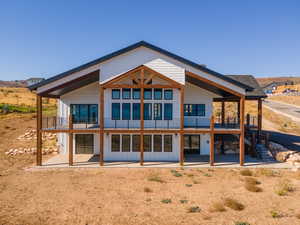 Back of property with a patio and a balcony