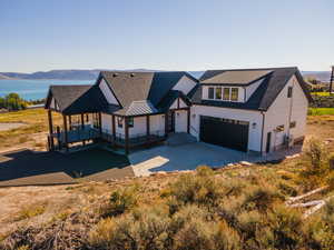 View of front facade with a mountain view, a porch, and a garage