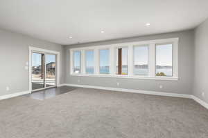 Family room featuring dark carpet, sliding glass door to patio, and breathtaking view