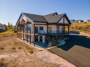 Rear view of property featuring covered porch