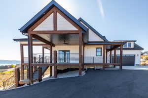 View of front of house with a porch, a garage, and ceiling fan