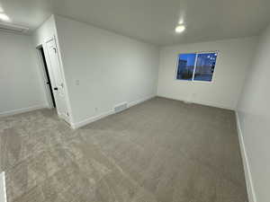 Spare room featuring light colored carpet