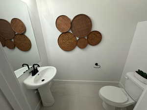 Bathroom featuring tile patterned floors and toilet