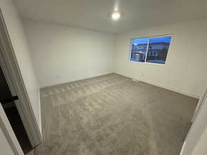 Unfurnished room with carpet