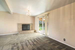 Dining area with fireplace, sliding doors, and carpet floors