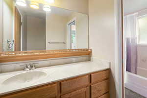 Bathroom featuring vanity and shower / bath combo