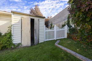 View of outdoor structure featuring a yard