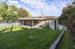 Back of house featuring a yard and a patio area