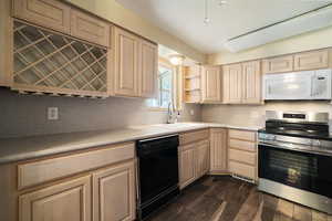 Kitchen with dishwasher, sink, stainless steel range, dark wood-type flooring, and light brown cabinets