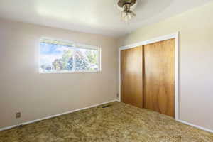 bedroom featuring a closet, carpet flooring, and ceiling fan